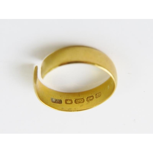 506 - An 18ct yellow gold wedding band; and a 22ct yellow gold wedding band (cut), 10.3gms gross.