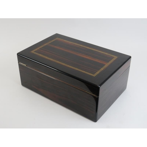 64 - A Dunhill humidor with parquetry inlaid cover, late 20th century. Key and dust cover included. 34.8 ... 