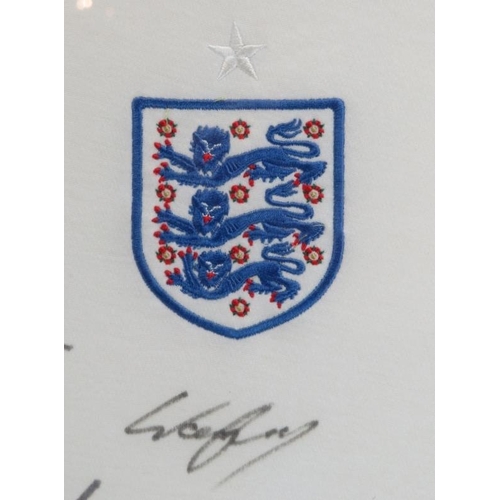 82 - An England Football Team training shirt signed by the England Team 2009/10. Wayne Rooney, Joleon Les... 