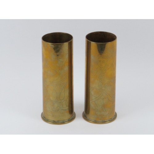 166 - Two WWI six pounder shells with unusual engraved figural decoration. Both dated 1917. (2 items) 18.5... 