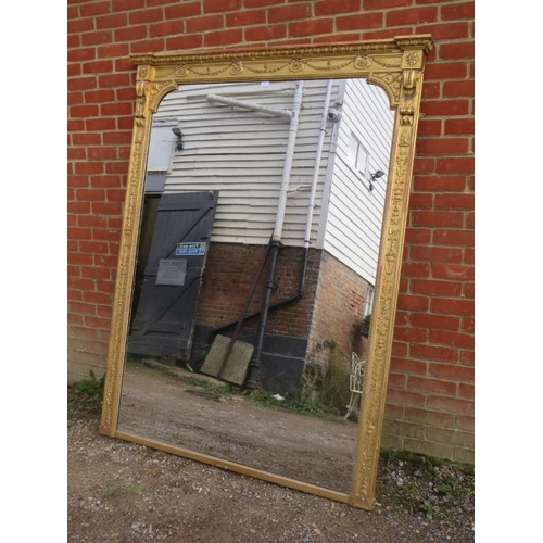 703 - A large Victorian over-mantle mirror, within an ornate gilt gesso surround, profusely decorated with... 