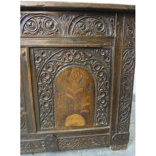 708 - An early 18th century oak panelled coffer, profusely carved with lunette frieze and arcaded front pa... 