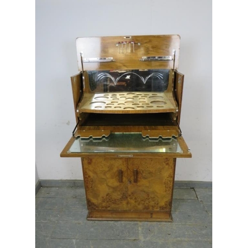 716 - An Art Deco Period burr walnut cocktail cabinet, the fall front and rising top opening to reveal a f... 