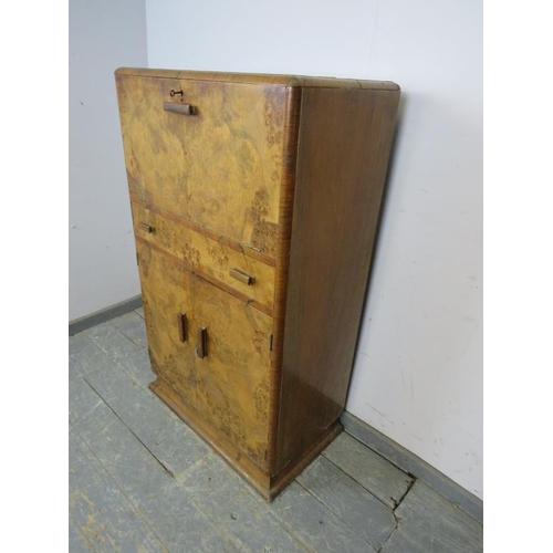 716 - An Art Deco Period burr walnut cocktail cabinet, the fall front and rising top opening to reveal a f... 