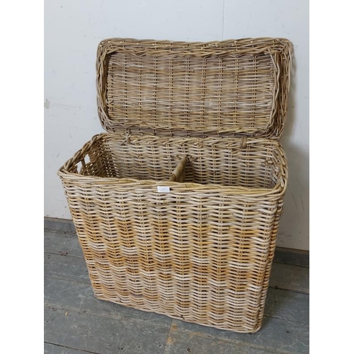 727 - An antique woven willow laundry basket, of unusually tall and narrow proportions, the hinged lid ope... 