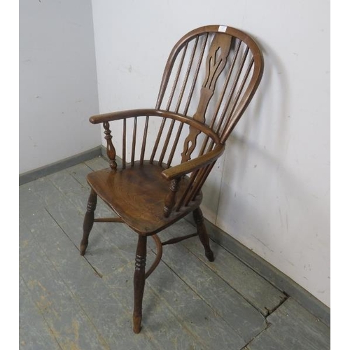 729 - A 19th century elm high-back Windsor chair, having shaped and pierced splat, on turned supports with... 