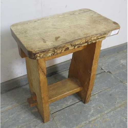 730 - A vintage primitive light oak stool, the top with live edge, on a peg-jointed base with pie-crust de... 