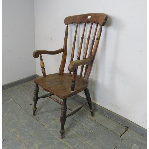 737 - A 19th century elm & beech farmhouse kitchen chair, having arcaded backrest and turned spindles, on ... 