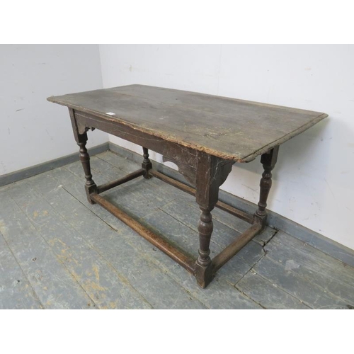 738 - An early 18th century oak side table, on turned and block supports with stretchers. 
H64 x W121 x D6... 