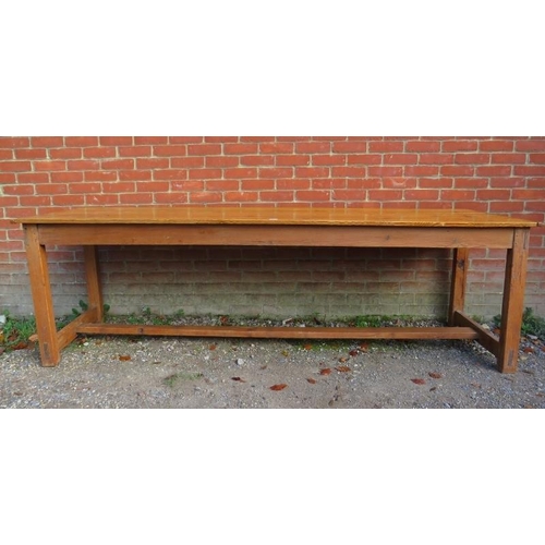 741 - A Continental antique pine long and narrow farmhouse kitchen table, the planked top on square suppor... 