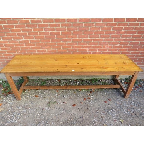 741 - A Continental antique pine long and narrow farmhouse kitchen table, the planked top on square suppor... 