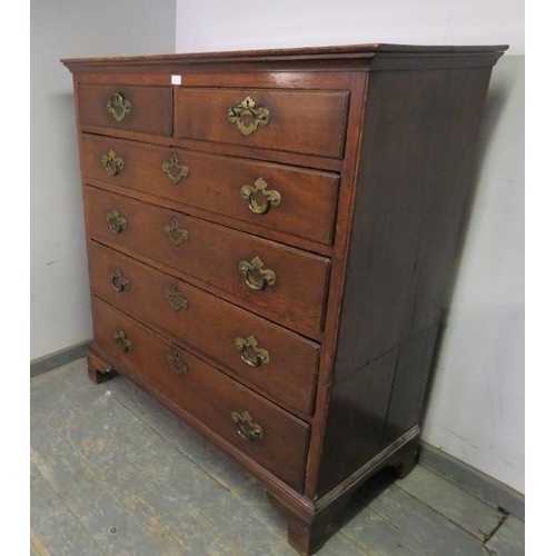 743 - An 18th century oak chest, housing two short and four long graduated drawers with pierced brass hand... 