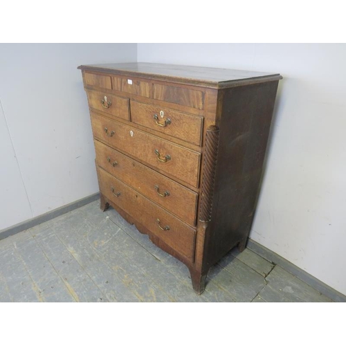 744 - A large George III oak chest, housing three blind drawers above two short and three long graduated d... 