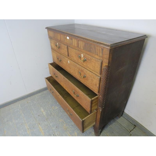 744 - A large George III oak chest, housing three blind drawers above two short and three long graduated d... 