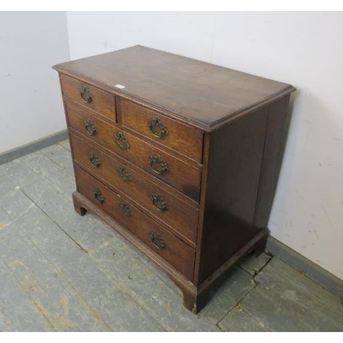 745 - An 18th century oak chest of small proportions, housing two short and three long graduated drawers w... 