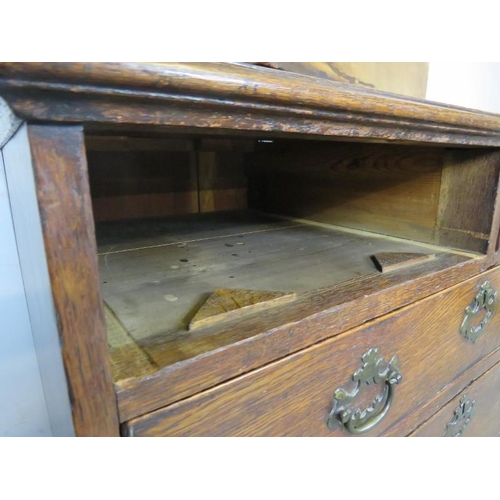 745 - An 18th century oak chest of small proportions, housing two short and three long graduated drawers w... 