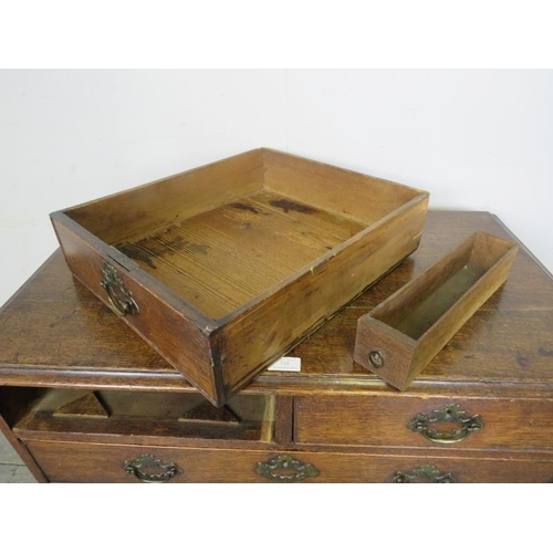 745 - An 18th century oak chest of small proportions, housing two short and three long graduated drawers w... 