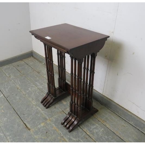 747 - An Edwardian mahogany set of four nesting tables strung with satinwood, on faux bamboo supports with... 