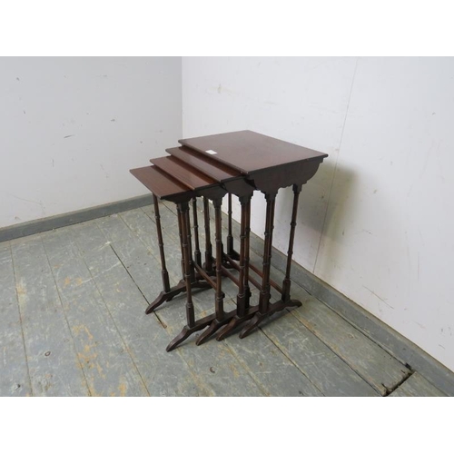 747 - An Edwardian mahogany set of four nesting tables strung with satinwood, on faux bamboo supports with... 