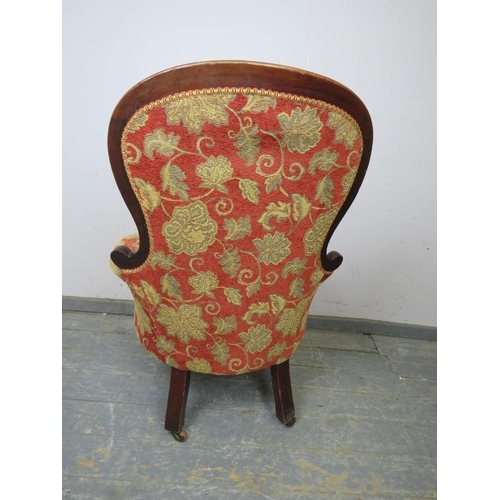 754 - A Victorian mahogany spoonback buttoned armchair, reupholstered in good quality foliate patterned ma... 