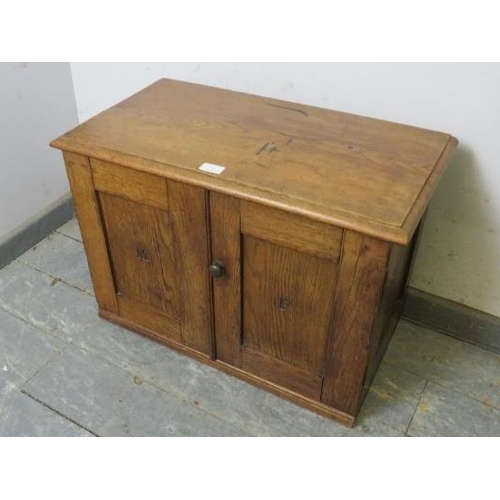 755 - A diminutive 19th century medium oak cabinet, the panelled doors with carved initials ‘MF’ and brass... 