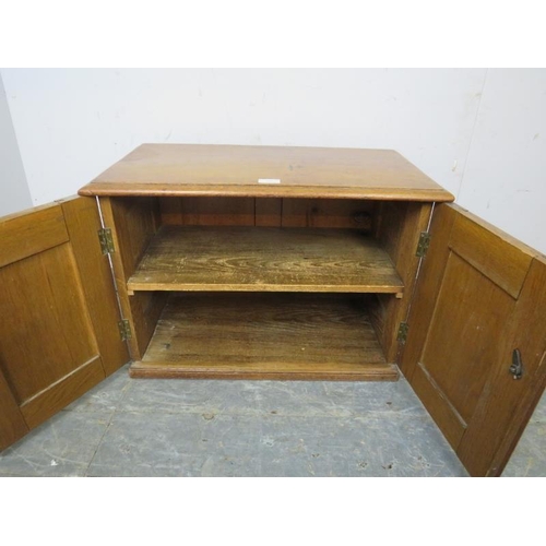 755 - A diminutive 19th century medium oak cabinet, the panelled doors with carved initials ‘MF’ and brass... 