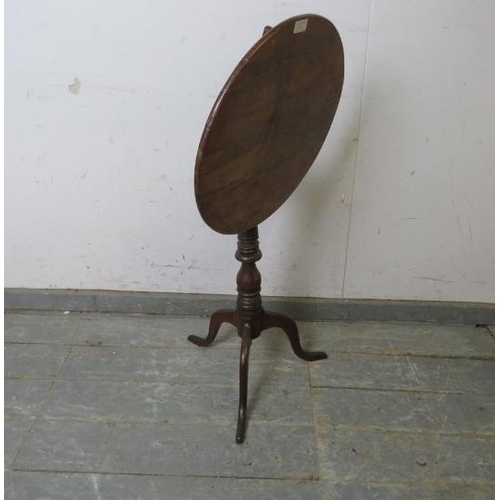 756 - A 19th century walnut and oak tilt-top wine table, on a turned pedestal with delicate splayed tripod... 