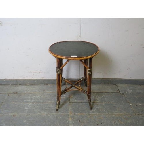 758 - An antique bamboo occasional table by Hampton & Son of Pall Mall, the circular top with inset black ... 