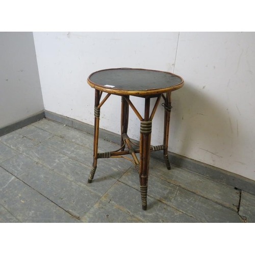 758 - An antique bamboo occasional table by Hampton & Son of Pall Mall, the circular top with inset black ... 