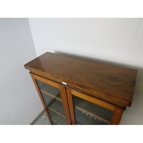 763 - A Victorian mahogany enclosed bookcase, the glazed doors opening onto three height adjustable shelve... 