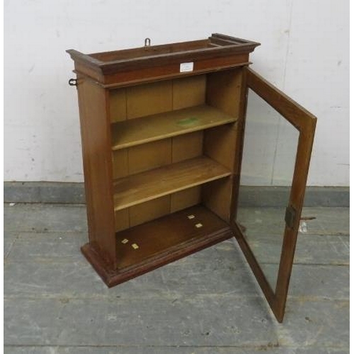 764 - A small antique mahogany wall hanging display cabinet, the glazed door opening onto two fitted shelv... 