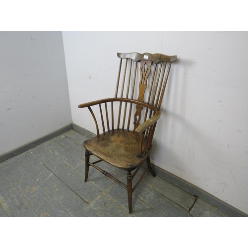 765 - An 18th century and later elm and beech stick-back Windsor chair, the shaped backrest and splat join... 