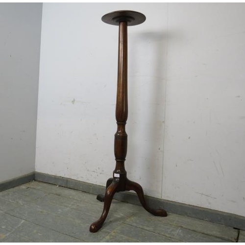 766 - A Victorian mahogany plant stand, the dished top on a turned column with splayed tripod supports. 
H... 