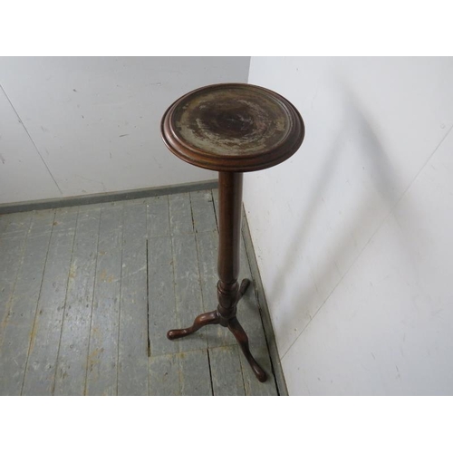 766 - A Victorian mahogany plant stand, the dished top on a turned column with splayed tripod supports. 
H... 