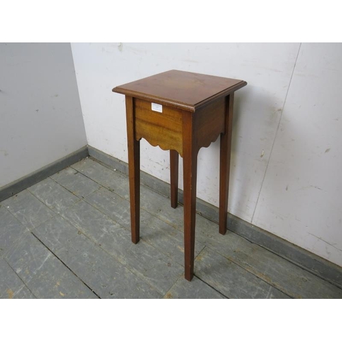 767 - An Arts & Crafts Period walnut plant stand/small side table, the square caddy top above a shaped fri... 