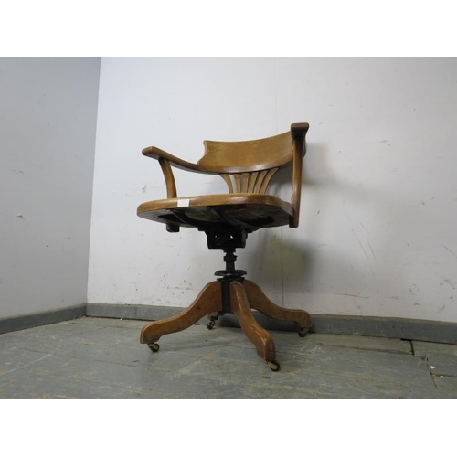 771 - An antique walnut captain’s desk chair, with revolving and tilt action, the seat upholstered in brow... 