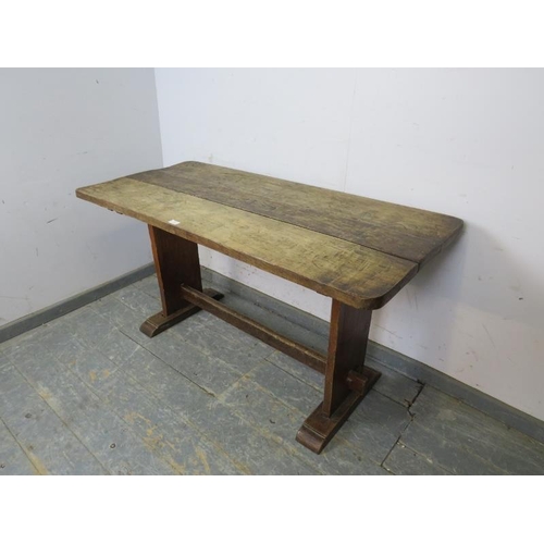 776 - An Arts & Crafts Period oak refectory table of small proportions, the planked top on stile end suppo... 