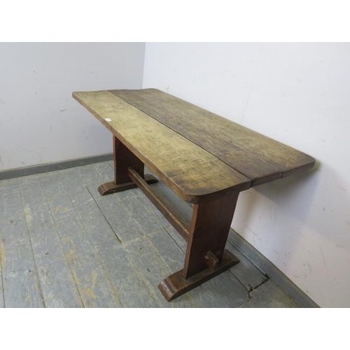 776 - An Arts & Crafts Period oak refectory table of small proportions, the planked top on stile end suppo... 