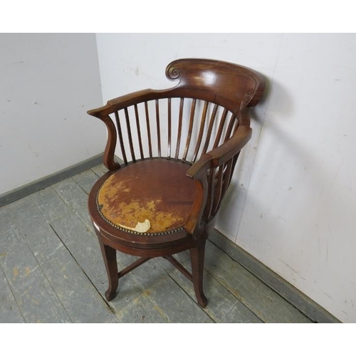 787 - An unusual Edwardian mahogany revolving desk chair, the shaped back above a seat pad upholstered in ... 