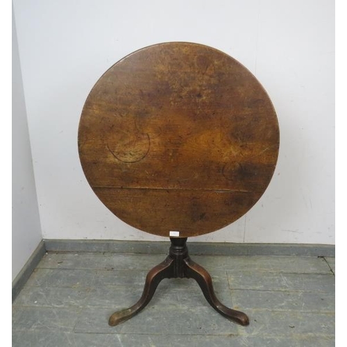 788 - A Georgian mahogany circular tilt-top supper table, on a plain column with splayed tripod supports.
... 