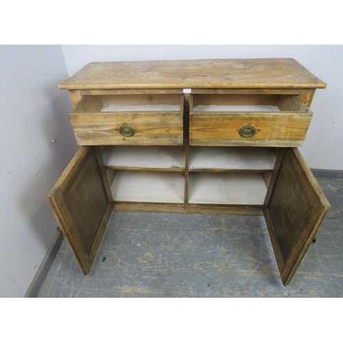 799 - An antique pine sideboard, housing two short drawers with pierced brass drop-ring handles, above cup... 