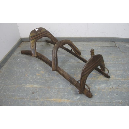 801 - An antique hardwood camel saddle originating from the Ottoman Empire, having tooled brass and cast-i... 