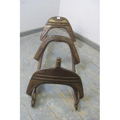 801 - An antique hardwood camel saddle originating from the Ottoman Empire, having tooled brass and cast-i... 