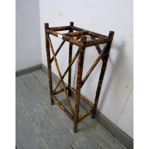 803 - A turn of the century colonial tiger bamboo stick stand, having two divided compartments. H71cm W36c... 