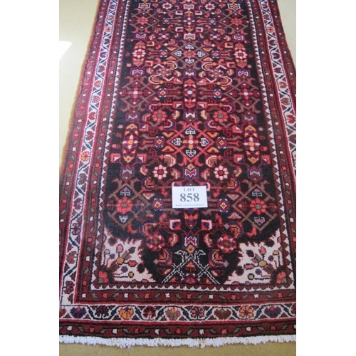 858 - A North West Persian Malayer runner.  A central snowdrop motif in cream on a colourful busy design. ... 