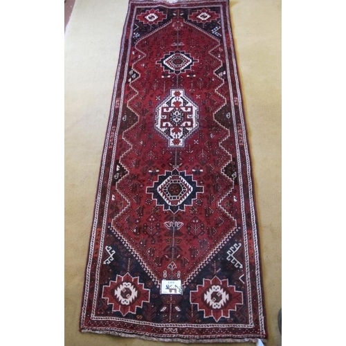 859 - South West Persian Qashqai Runner, three large central motifs on red ground. 275cm x 97cm approx.
Co... 