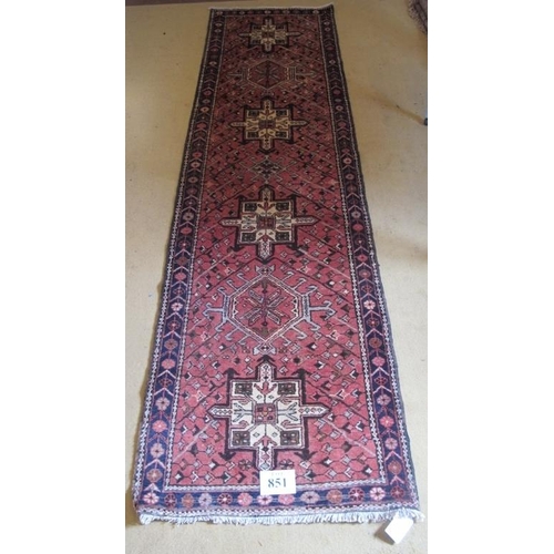 860 - A North West Persian Heriz runner, central repeat motif on salmon ground and in very good condition.... 