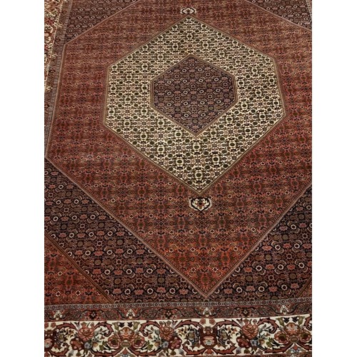 861 - 20th Century Persian Bidjar carpet with central diamond motif on pale pink ground. 332 cm x 256 cm a... 