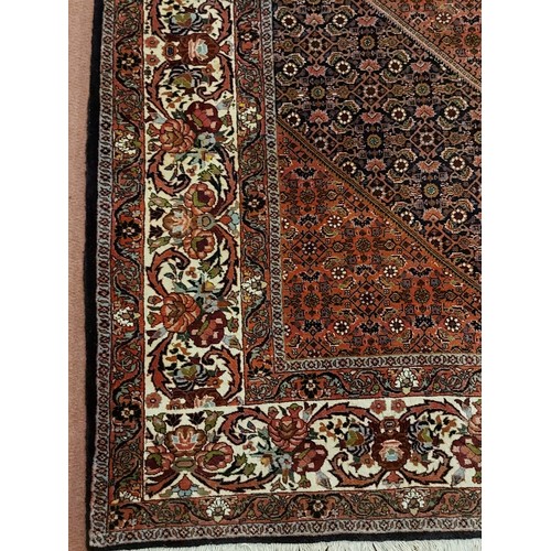 861 - 20th Century Persian Bidjar carpet with central diamond motif on pale pink ground. 332 cm x 256 cm a... 