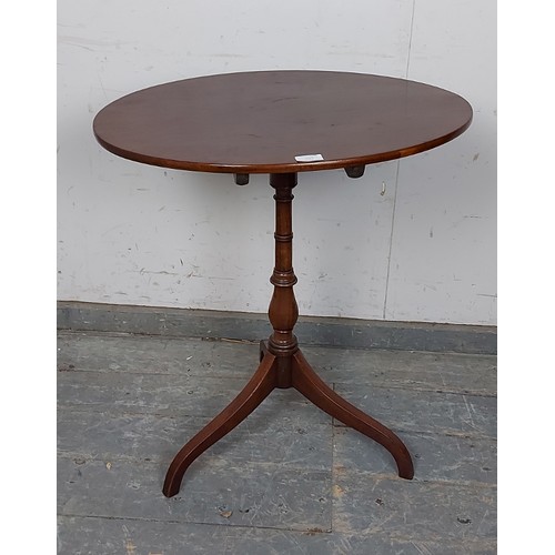 733 - A 19th century oval mahogany tilt-top wine table, on a faux bamboo turned column with delicate tripo... 